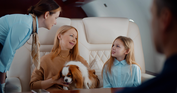 mom, dog, and daughter in private jet